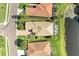 Aerial view of a house with a brown tile roof and a screened-in pool, backing onto a picturesque lake at 643 Misty Pond Ct, Bradenton, FL 34212