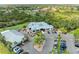 Aerial view showcases clubhouse, golf course and cart parking with beautiful surrounding landscape at 643 Misty Pond Ct, Bradenton, FL 34212