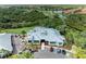 Aerial view showcases clubhouse, golf course, and cart parking with beautiful surrounding landscaping at 643 Misty Pond Ct, Bradenton, FL 34212