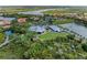 Stunning aerial view of a waterfront community, golf course, club house and surrounding nature at 643 Misty Pond Ct, Bradenton, FL 34212