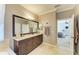 Bathroom with granite counters, dark wood cabinets, and a walk-in shower with a neutral color palette at 643 Misty Pond Ct, Bradenton, FL 34212