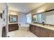 Spacious bathroom with dual sinks, soaking tub, walk-in shower, granite counters, and dark wood cabinets at 643 Misty Pond Ct, Bradenton, FL 34212