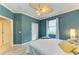 Comfortable bedroom featuring crown molding, a ceiling fan, plush bed, bright window, and wood-look floors at 643 Misty Pond Ct, Bradenton, FL 34212
