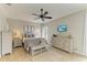 Comfortable bedroom with neutral color scheme, ceiling fan, and ample natural light at 643 Misty Pond Ct, Bradenton, FL 34212