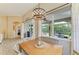 Bright dining area with views of outdoor living space and access to screened patio at 643 Misty Pond Ct, Bradenton, FL 34212
