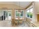 Dining area with natural light, stylish light fixture, and view of the backyard at 643 Misty Pond Ct, Bradenton, FL 34212