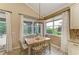 Bright dining area with big windows, a view of the backyard, and a hanging light fixture at 643 Misty Pond Ct, Bradenton, FL 34212