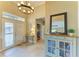 Inviting entryway with decorative mirror, tiled floor, and stylish chandelier creates a welcoming atmosphere at 643 Misty Pond Ct, Bradenton, FL 34212