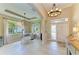 Bright foyer featuring tile flooring, stylish lighting, and an open view to the living space at 643 Misty Pond Ct, Bradenton, FL 34212