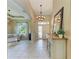 Welcoming foyer with tile flooring, elegant lighting, and a glimpse into the spacious living area at 643 Misty Pond Ct, Bradenton, FL 34212