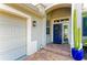 Front entrance of home has a blue door and a brick paver landing at 643 Misty Pond Ct, Bradenton, FL 34212