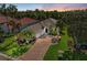 Beautiful one-story home features lush landscaping, palm trees, and a brick paver driveway at 643 Misty Pond Ct, Bradenton, FL 34212