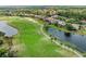 Scenic golf course view featuring lush greens, a sand trap, and water features with neighborhood at 643 Misty Pond Ct, Bradenton, FL 34212