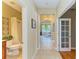 Inviting hallway with tile flooring leads to a full bathroom and bright living room with decorative lighting features at 643 Misty Pond Ct, Bradenton, FL 34212