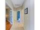 Hallway with neutral colored walls, multiple doors, and ceramic tile flooring at 643 Misty Pond Ct, Bradenton, FL 34212