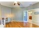 Bright office area featuring hardwood floors, desk, chair, ceiling fan, and access to an adjacent bathroom at 643 Misty Pond Ct, Bradenton, FL 34212