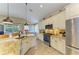 Bright, modern kitchen with stainless steel appliances, granite countertops, and open view of outdoor living space at 643 Misty Pond Ct, Bradenton, FL 34212