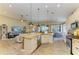 Open-concept kitchen featuring a center island, stainless steel appliances, and views of the living and dining areas at 643 Misty Pond Ct, Bradenton, FL 34212