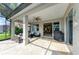 Covered lanai with an outdoor grill, travertine tile, outdoor seating, and access to interior dining at 643 Misty Pond Ct, Bradenton, FL 34212