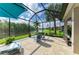 Inviting screened lanai with patio seating, chaise lounge and an amazing view of the lake at 643 Misty Pond Ct, Bradenton, FL 34212