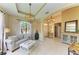 Bright and open living room with tile flooring, modern lighting, and views to the foyer at 643 Misty Pond Ct, Bradenton, FL 34212