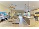 Open-concept living room and kitchen boasting modern appliances, island with seating, and comfortable furnishings at 643 Misty Pond Ct, Bradenton, FL 34212
