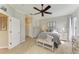 Bright bedroom featuring a ceiling fan, a dresser with a television, and a comfortable bed at 643 Misty Pond Ct, Bradenton, FL 34212