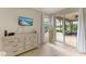 Main bedroom features a dresser with a television and sliding glass doors to the patio at 643 Misty Pond Ct, Bradenton, FL 34212