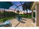 Serene screened patio with inviting seating and a picturesque view of the tranquil waterfront at 643 Misty Pond Ct, Bradenton, FL 34212