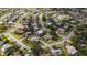 Aerial neighborhood view showing a home with a screened pool in a residential area at 6583 Waterford Cir, Sarasota, FL 34238