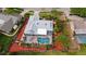Aerial view of a home with a screened-in pool and well-maintained landscaping at 6583 Waterford Cir, Sarasota, FL 34238