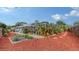Spacious backyard with mulch landscaping, raised garden bed, and screened-in patio at 6583 Waterford Cir, Sarasota, FL 34238