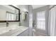 Bathroom with a white sink, grey walls, white cabinets, a mirror and a curtained shower at 6583 Waterford Cir, Sarasota, FL 34238