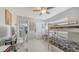 Bedroom featuring bunk beds, a desk, a ceiling fan, a shelf with decor and white floors at 6583 Waterford Cir, Sarasota, FL 34238