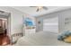 Bedroom with a queen-sized bed, a ceiling fan, blinds, a dresser and a TV screen at 6583 Waterford Cir, Sarasota, FL 34238