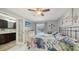 Charming bedroom with en-suite bathroom and sliding glass doors to the pool area at 6583 Waterford Cir, Sarasota, FL 34238