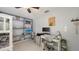 Bedroom featuring bunk beds, a desk, a ceiling fan, a shelf with decor and white floors at 6583 Waterford Cir, Sarasota, FL 34238