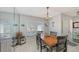 Bright dining space with a view through large windows and a decorative chandelier at 6583 Waterford Cir, Sarasota, FL 34238