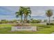 A sign that reads 'Gulf Gate East' surrounded by palm trees, pond and manicured landscaping at 6583 Waterford Cir, Sarasota, FL 34238