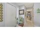 Inviting entryway features a decorative cabinet, mirror and access to a bright home office at 6583 Waterford Cir, Sarasota, FL 34238