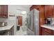 Well-lit kitchen featuring stainless steel appliances, tile floors, and dark wood cabinetry at 6583 Waterford Cir, Sarasota, FL 34238
