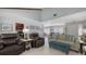 Open-concept living room with tile floors, comfortable seating, and easy access to the kitchen and dining at 6583 Waterford Cir, Sarasota, FL 34238