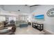 Inviting living room with tile floors, a comfortable seating area and access to dining and kitchen at 6583 Waterford Cir, Sarasota, FL 34238