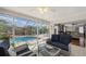 Bright sun room with comfortable seating and a view of the sparkling pool, perfect for relaxation at 6583 Waterford Cir, Sarasota, FL 34238