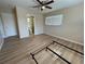 This bedroom features wood floors, a ceiling fan, and bright natural light at 6912 10Th W Ave, Bradenton, FL 34209