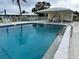 A beautiful community pool has a nearby pavilion with table and chairs for a great social space at 6912 10Th W Ave, Bradenton, FL 34209
