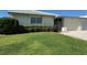 A well-maintained villa boasts lush landscaping, a garage, and a cozy front entrance at 6912 10Th W Ave, Bradenton, FL 34209