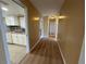 Hallway that leads to the kitchen and dining area and has tile flooring at 6912 10Th W Ave, Bradenton, FL 34209