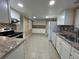Open kitchen featuring updated cabinets, granite countertops, tile backsplash and stainless appliances at 6912 10Th W Ave, Bradenton, FL 34209
