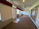 Enclosed lanai featuring sliding glass doors, carpeting, ceiling fan, and view of the yard at 6912 10Th W Ave, Bradenton, FL 34209